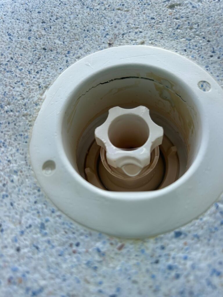 Crack running through the throat of a pool return wall fitting found during a leak detection inspection