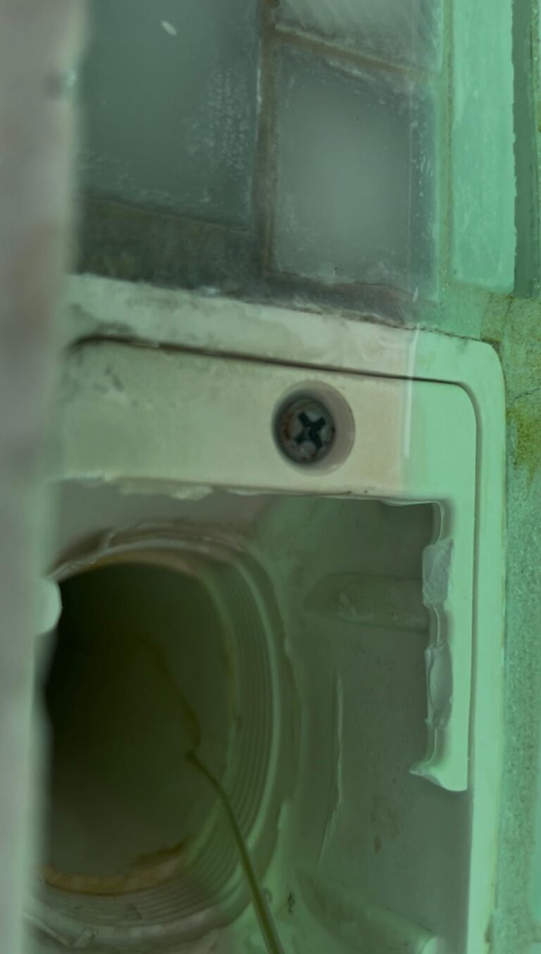 Interior of a pool autofill valve housing showing mineral scale buildup around the fill line