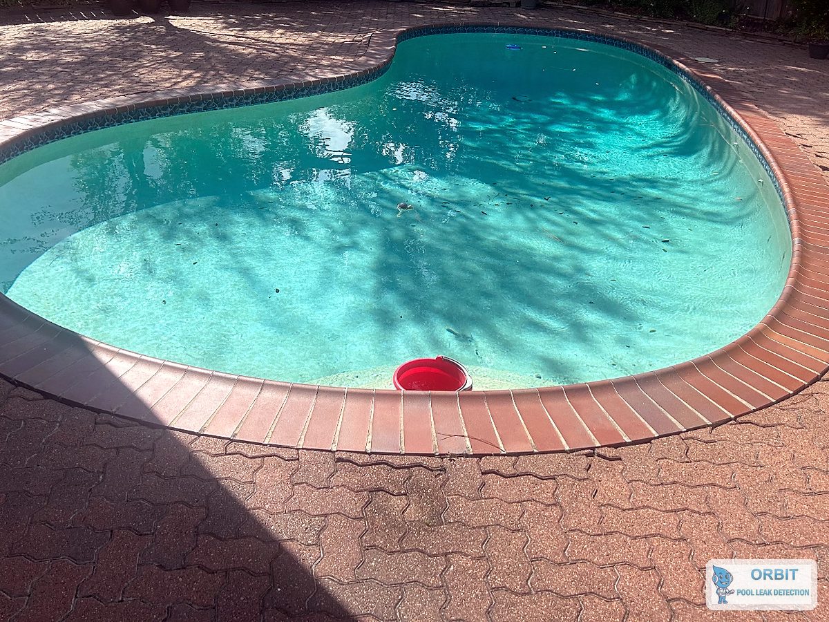 Concrete pool with a brick deck in Houston, TX, tested for leaks line by line