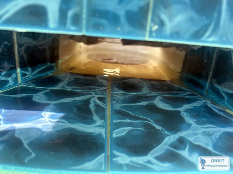 Far skimmer throat on a tiled concrete pool in Houston, TX, checked during leak detection