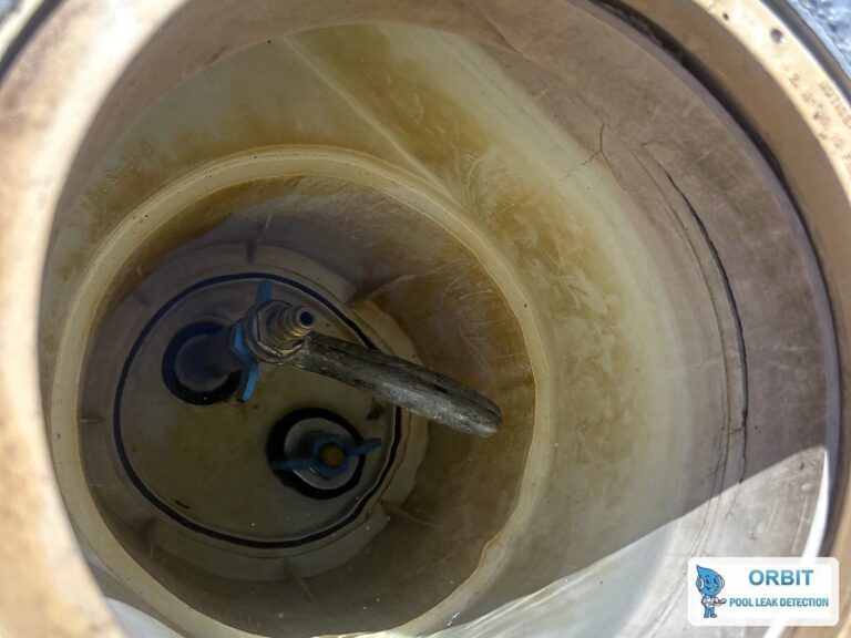 Pool skimmer inspected for hollow spots and cracks during leak detection in Houston, TX